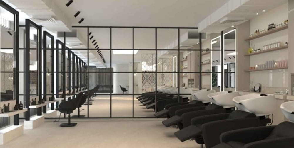 The styling row in the new space: mirrors and chairs behind a black steel partition.